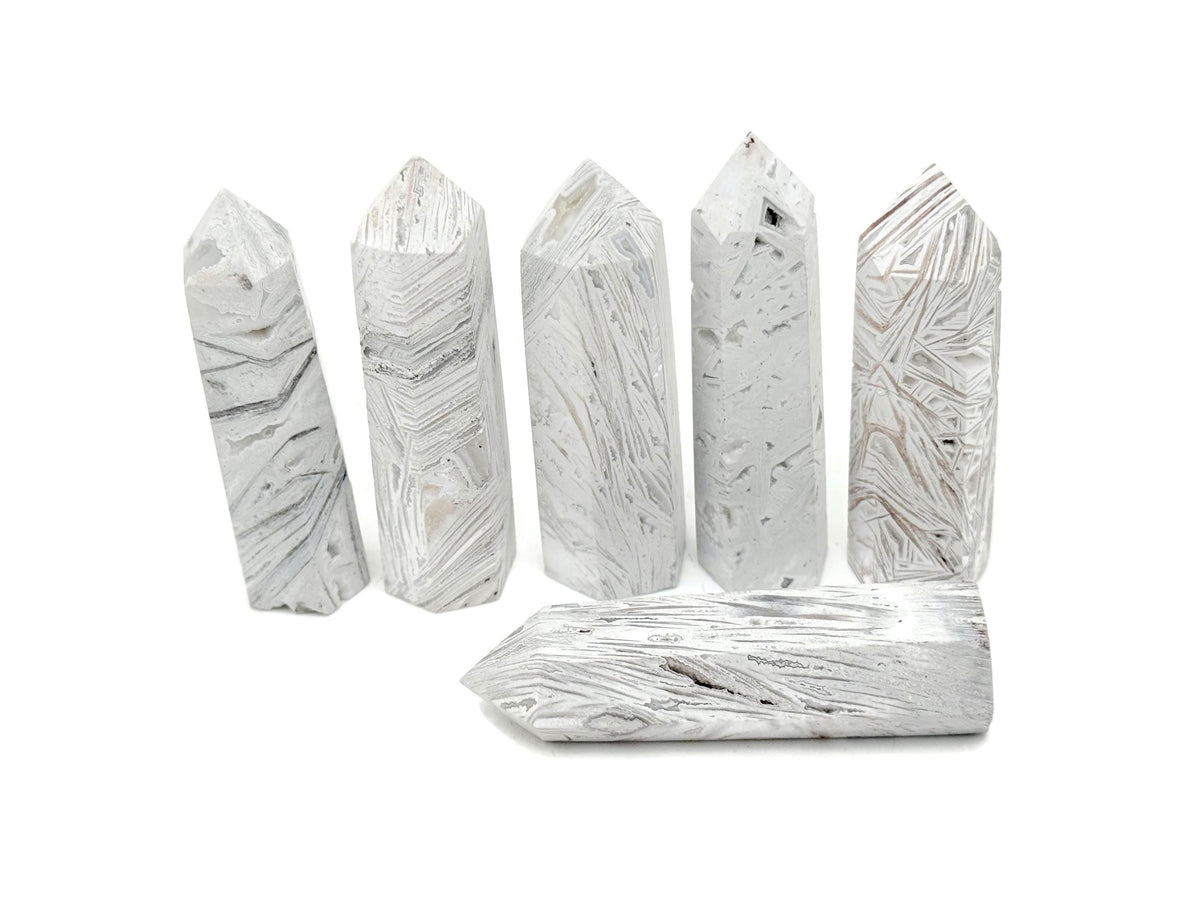 Mexican White Agate obelisk tower crystal by GemstoneGO, showcasing smooth polished surface and natural white veining.