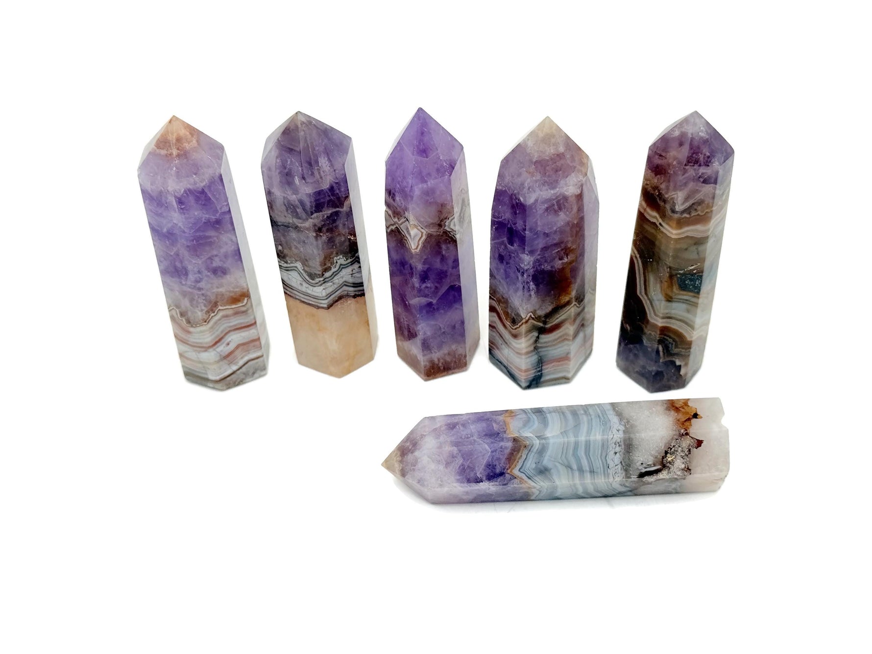 Amethyst Crazy Lace Agate obelisk tower crystal from GemstoneGO, showcasing purple and patterned banding on a polished stone.