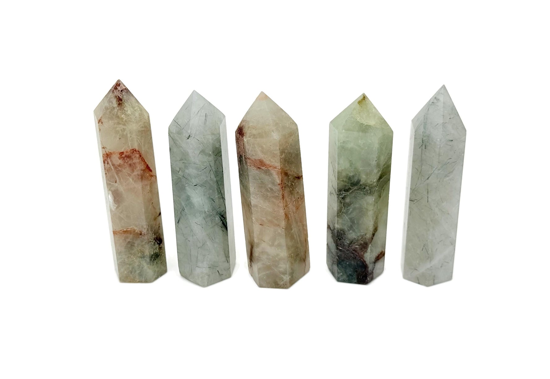 Green rutilated quartz obelisk tower crystal from GemstoneGO, showcasing a polished green quartz with natural rutile inclusions.