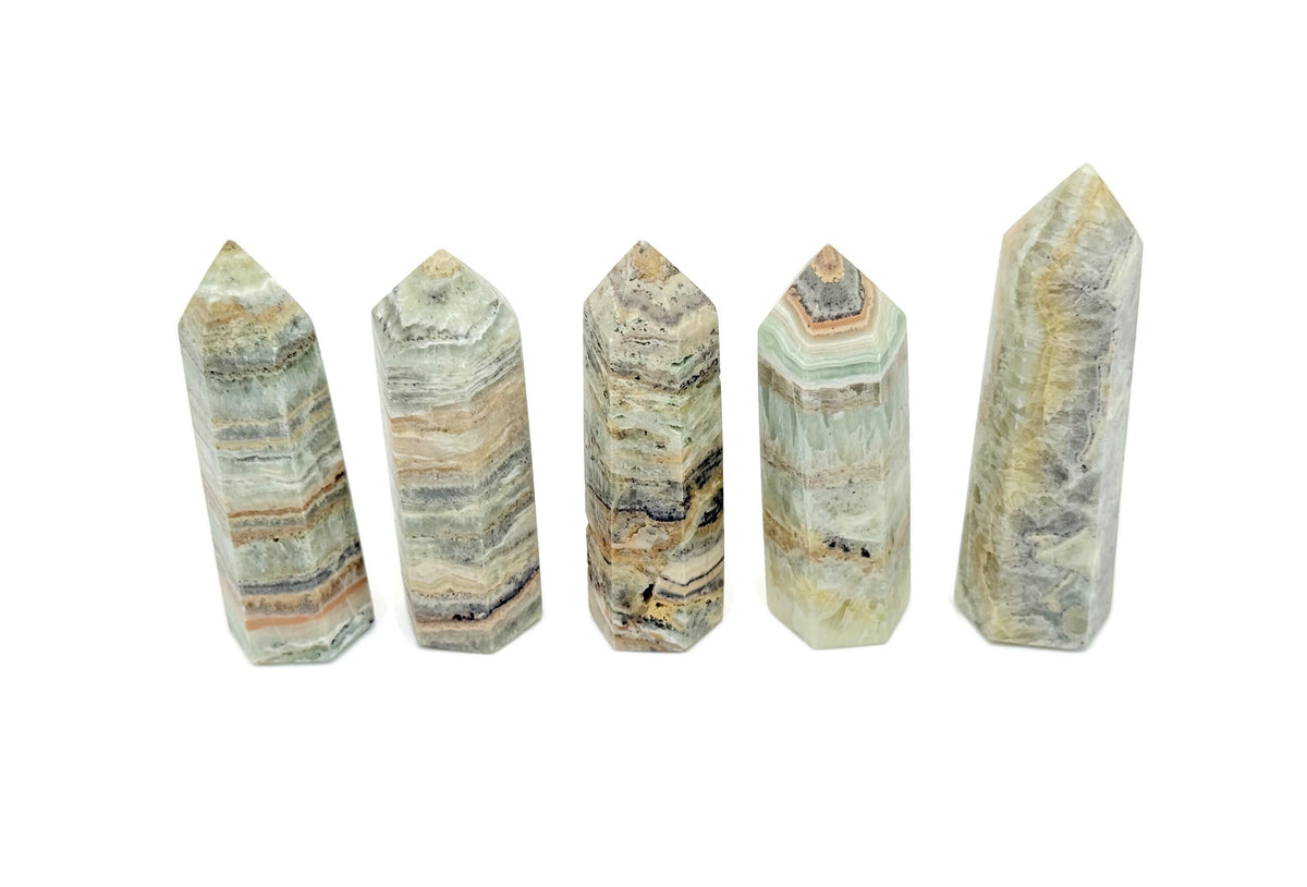 Caribbean green calcite obelisk tower crystal from GemstoneGO, showing smooth polished surface and vibrant green color.