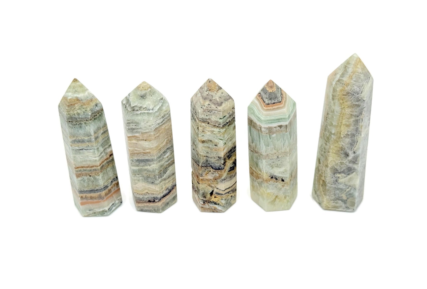 Caribbean green calcite obelisk tower crystal from GemstoneGO, showing smooth polished surface and vibrant green color.