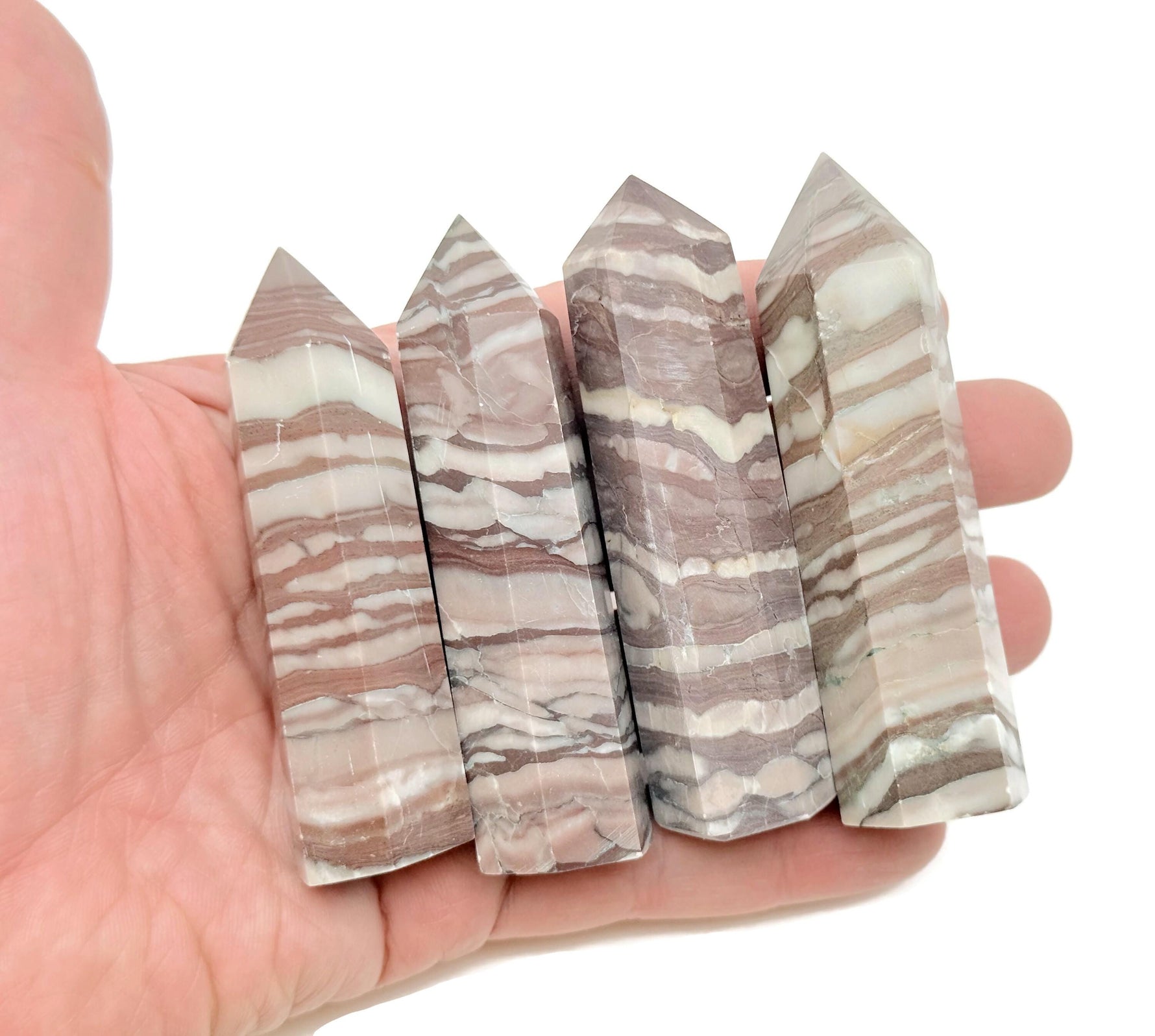 Red zebra calcite obelisk tower crystal with vibrant red and white striped patterns, polished surface, and pointed tip.