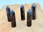 Garnet Obelisk Tower crystal from GemstoneGO, featuring a deep red gemstone carved into a tall obelisk shape.