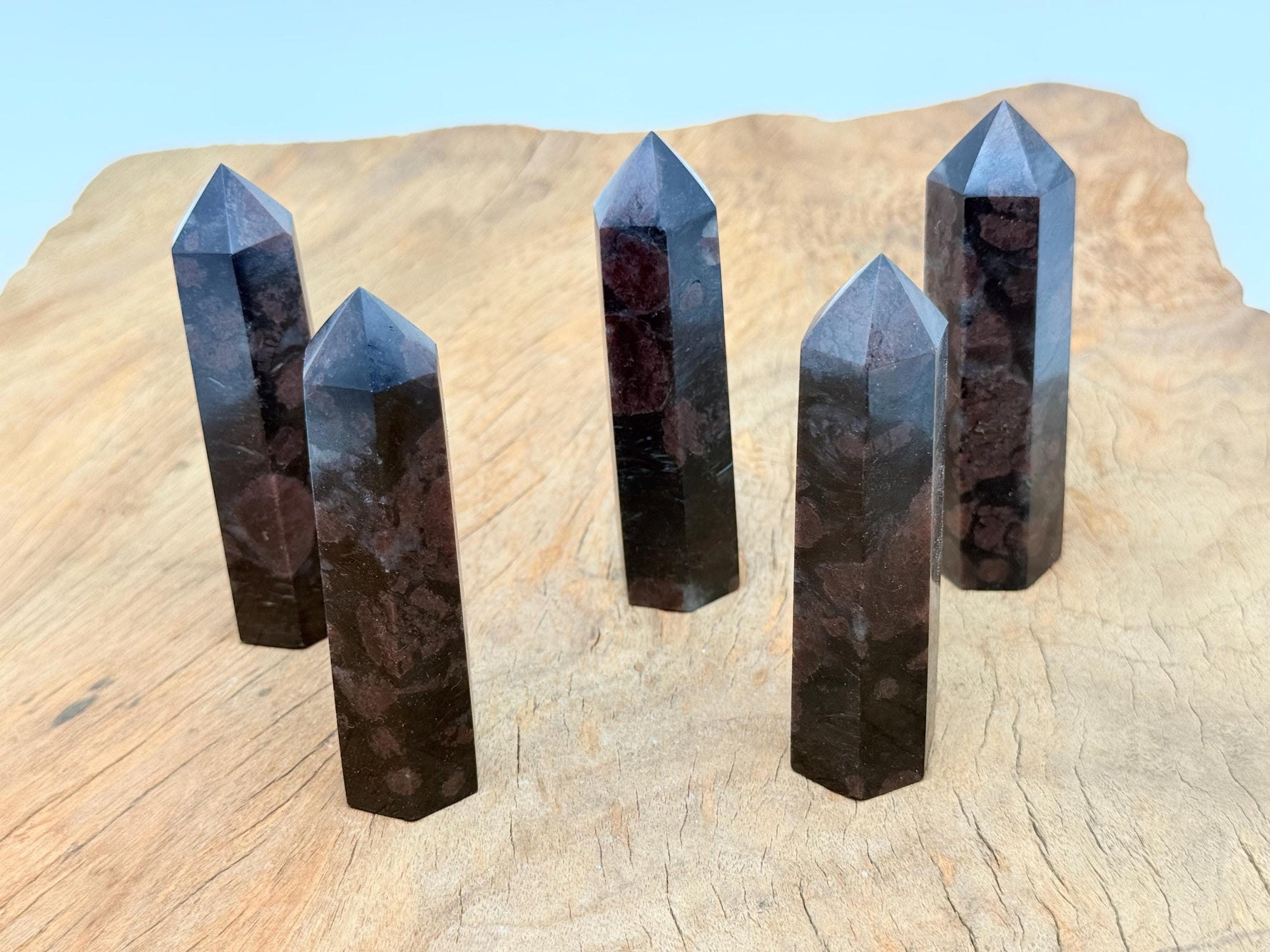 Garnet Obelisk Tower crystal from GemstoneGO, featuring a deep red gemstone carved into a tall obelisk shape.