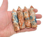 Sunstone and Blue Apatite obelisk tower crystal from GemstoneGO, showcasing vibrant orange and blue mineral formations.