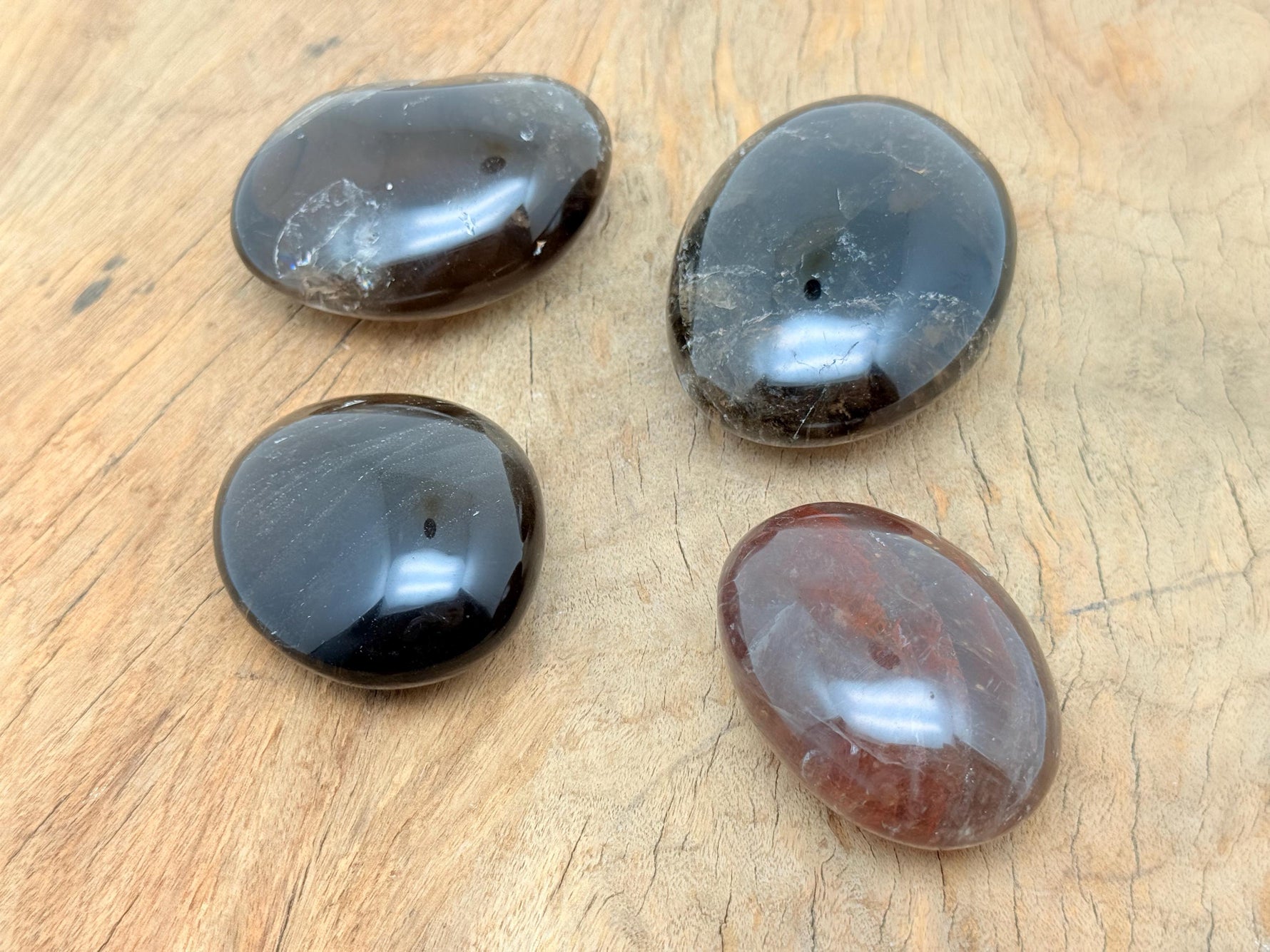 Smoky quartz palm gemstone spa stone from GemstoneGO, showcasing a polished, natural smoky quartz crystal for relaxation or meditation.