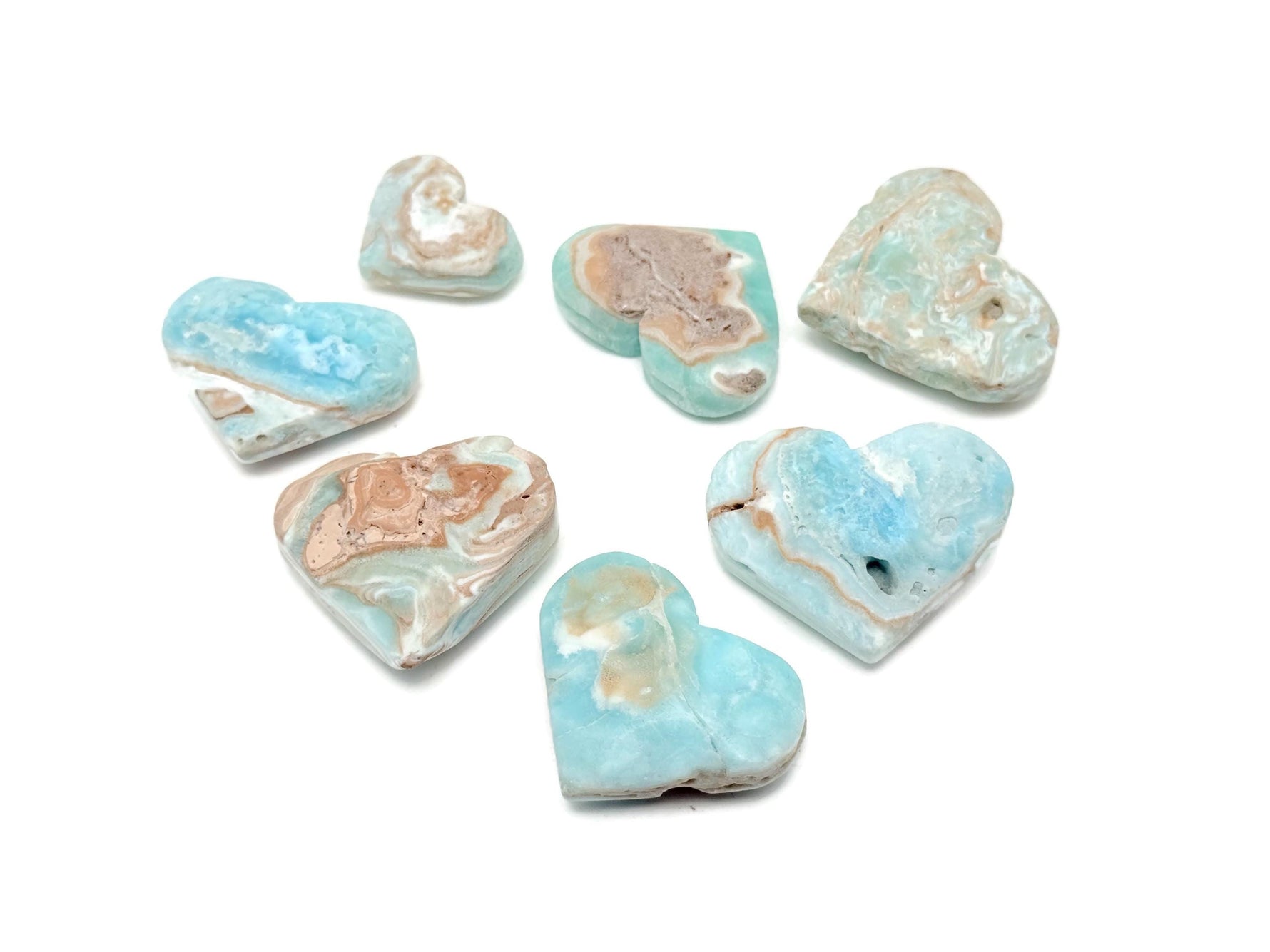 Caribbean Calcite Heart gemstone from GemstoneGO showing a polished, pink-orange mineral heart with natural patterns and smooth surface.