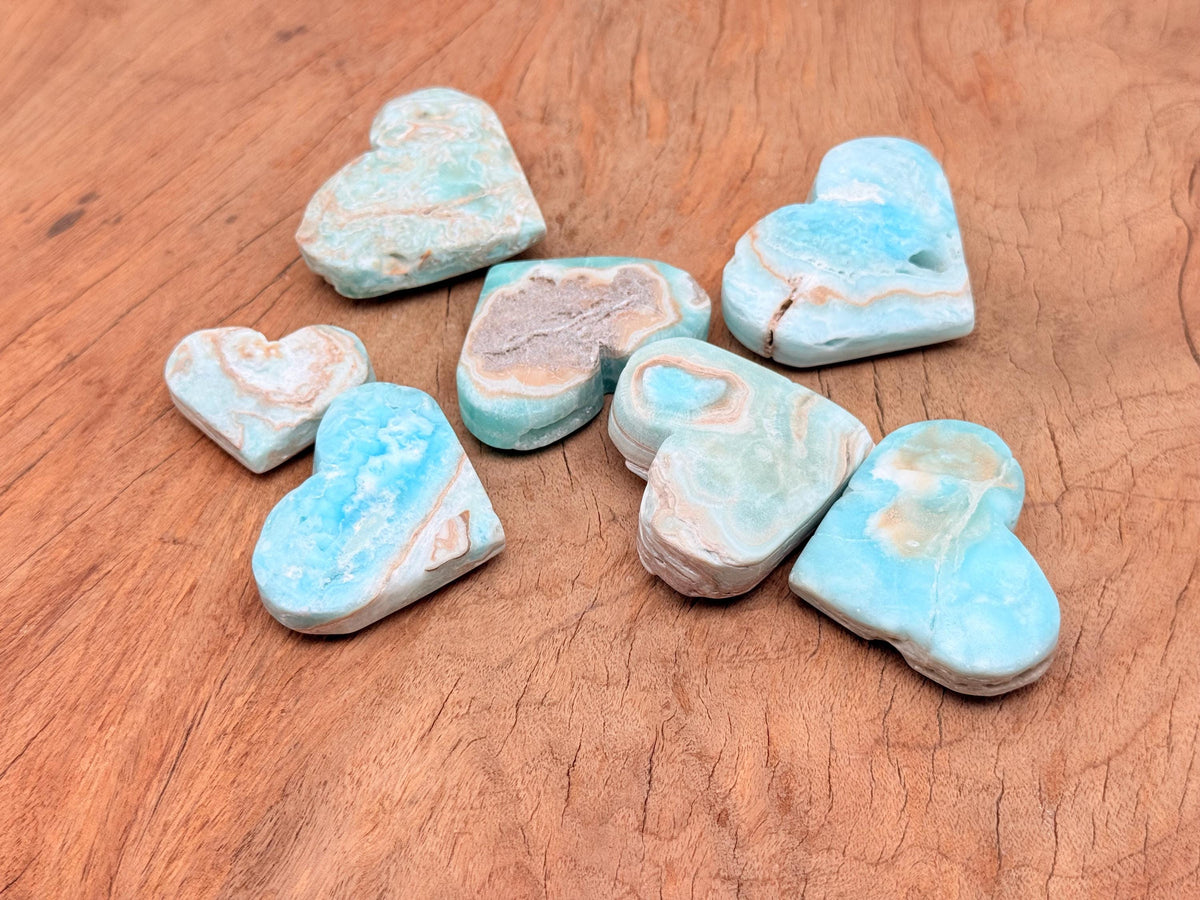 Caribbean Calcite Heart gemstone from GemstoneGO showing a polished orange and yellow calcite heart-shaped mineral.