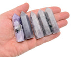 Lepidolite obelisk tower crystal from GemstoneGO, showcasing purple and pink hues with natural mineral patterns.