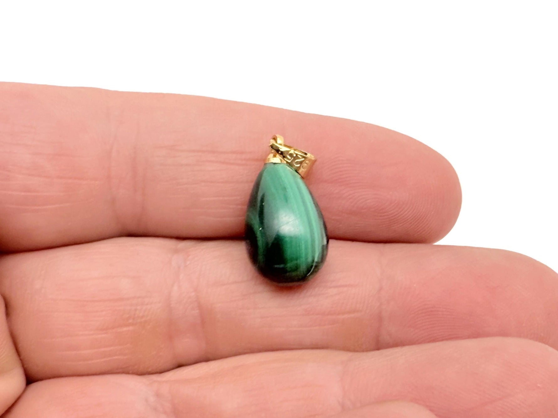 Malachite crystal pendant from GemstoneGO featuring a polished green stone with silver bail for spiritual protection jewelry.