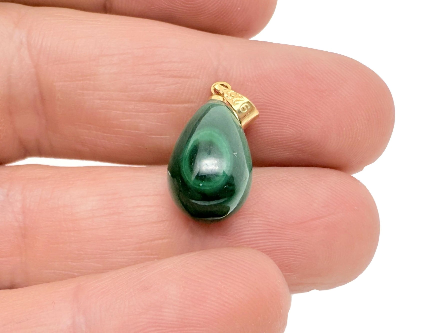 Malachite crystal pendant from GemstoneGO featuring a polished green stone with silver bail, ideal for spiritual protection jewelry.