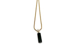 Malachite cylinder crystal necklace with gold chain from GemstoneGO, featuring a polished green stone pendant for protection and power.