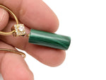 Malachite cylinder crystal pendant necklace with gold chain, showcasing protective and powerful gemstone jewelry.