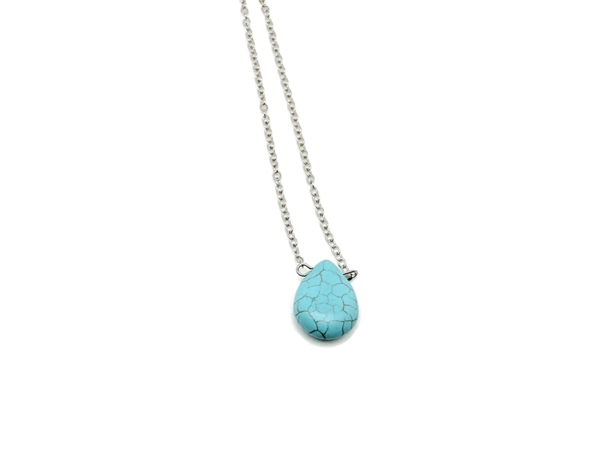 Turquoise synthetic necklace from GemstoneGO featuring beads for protection and balance on a neutral background.