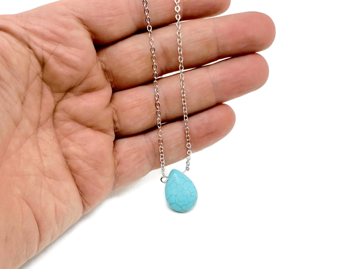 Turquoise synthetic necklace from GemstoneGO featuring a beaded design for protection and balance, displayed on a neutral background.