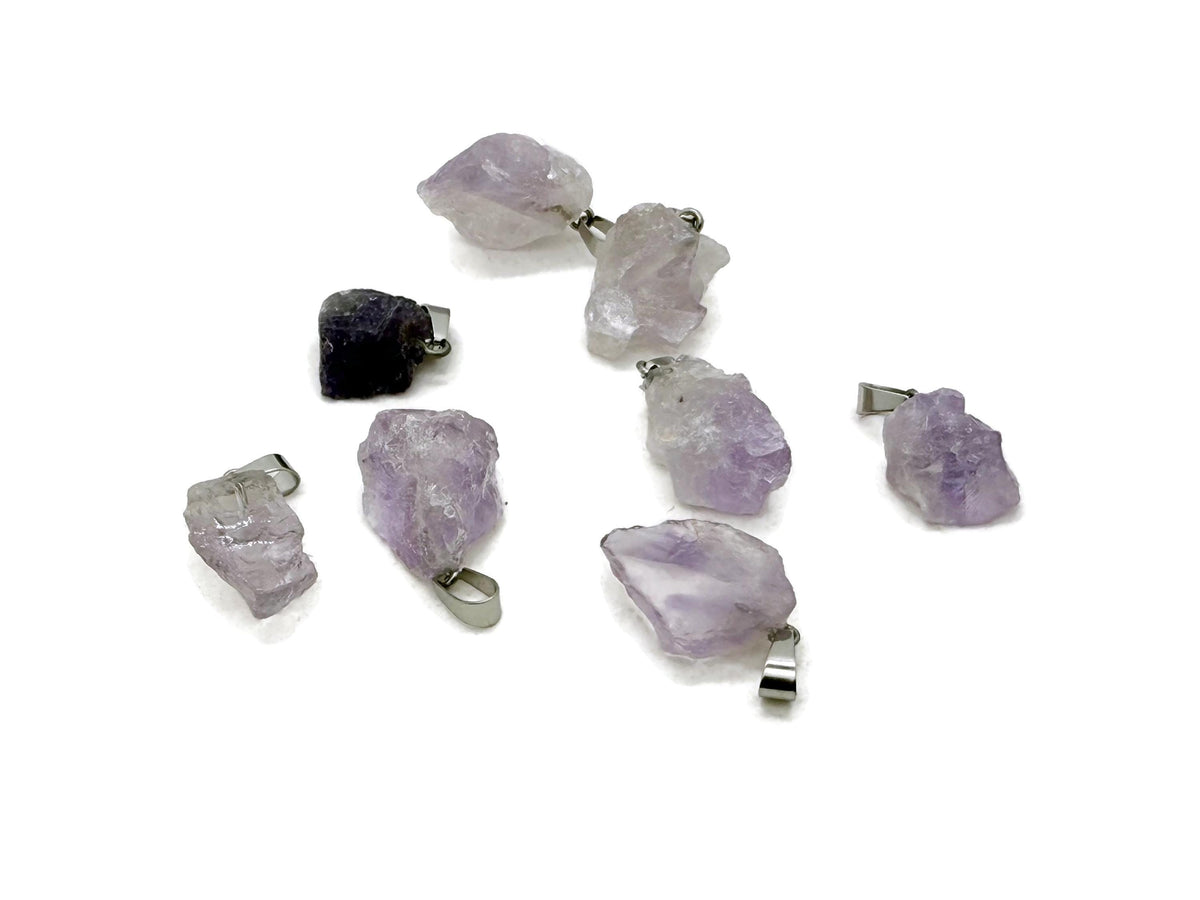 Amethyst crystal pendant from GemstoneGO, showcasing a polished purple gemstone with a silver bail for jewelry making.