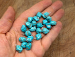 Turquoise crystal pendant with blue stones from GemstoneGO, featuring a polished, elegant jewelry design on a silver chain.