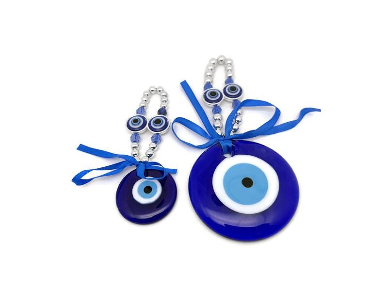Blue glass Turkish evil eye charm with intricate design, believed to protect and bring good luck, ideal as a healing gift or home decor.