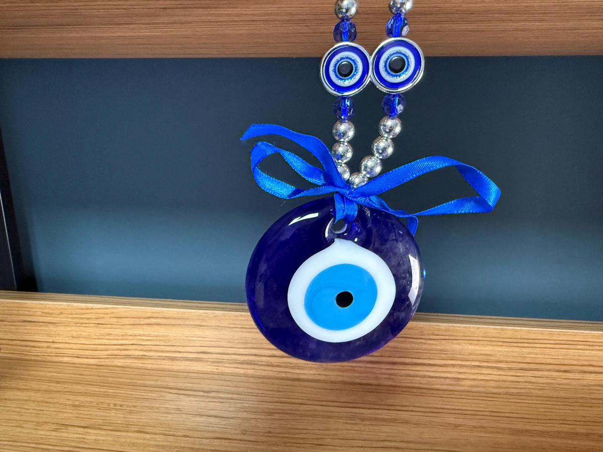 Blue glass evil eye charm from GemstoneGO featuring a traditional Turkish Nazar design for protection and home decor.