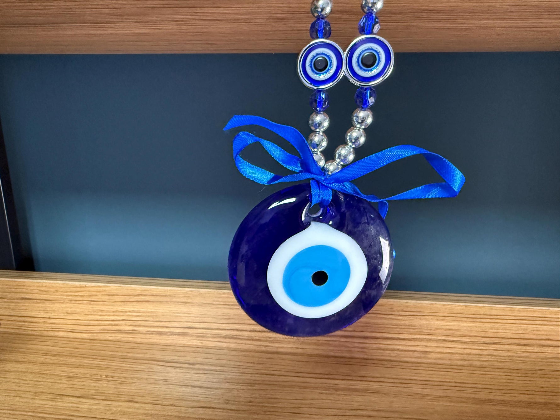 Blue glass evil eye charm from GemstoneGO featuring a traditional Turkish Nazar design for protection and home decor.
