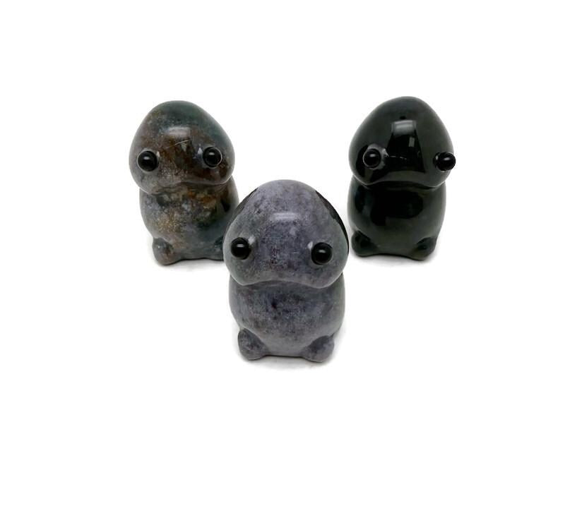 Handcrafted moss agate frog monster gemstone carving, detailed creature statue with natural stone patterns and textures.