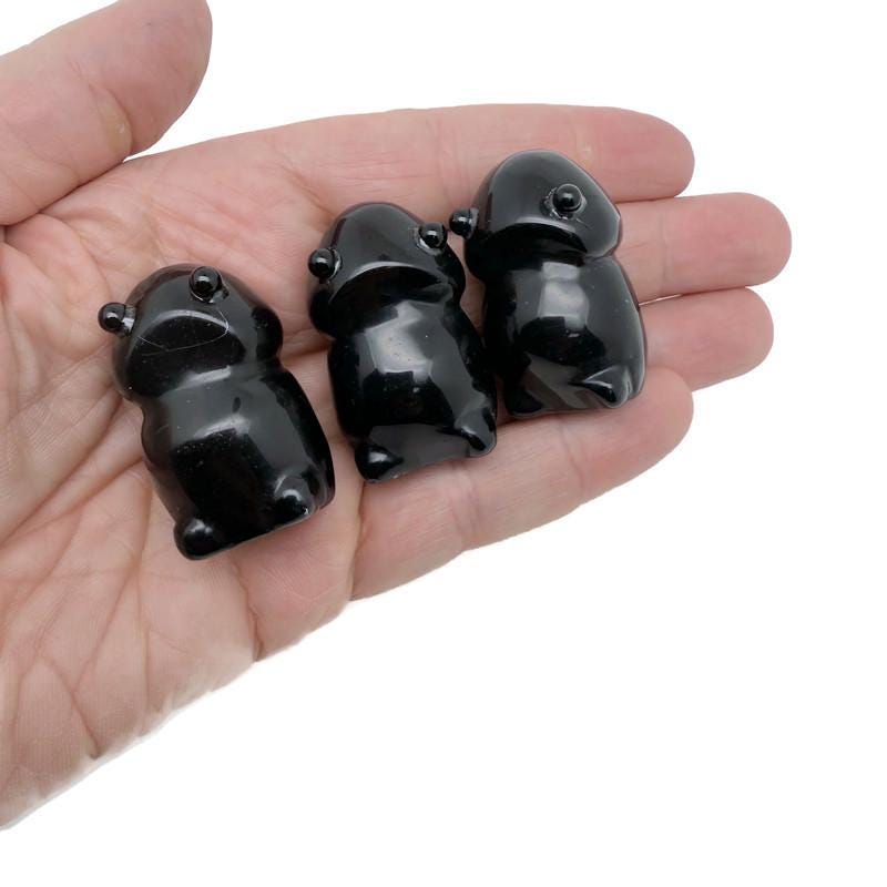 Handcrafted obsidian frog monster gemstone carving featuring detailed creature design on a polished base.