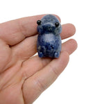 Handcrafted sodalite frog monster gemstone carving with detailed features and vibrant blue and white stone patterns.