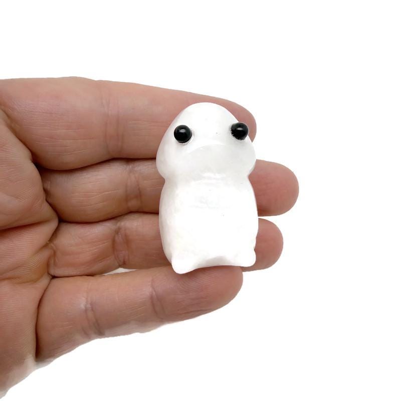 Handcrafted clear quartz frog sculpture with detailed gemstone carving, showcasing a whimsical creature statue from GemstoneGO.