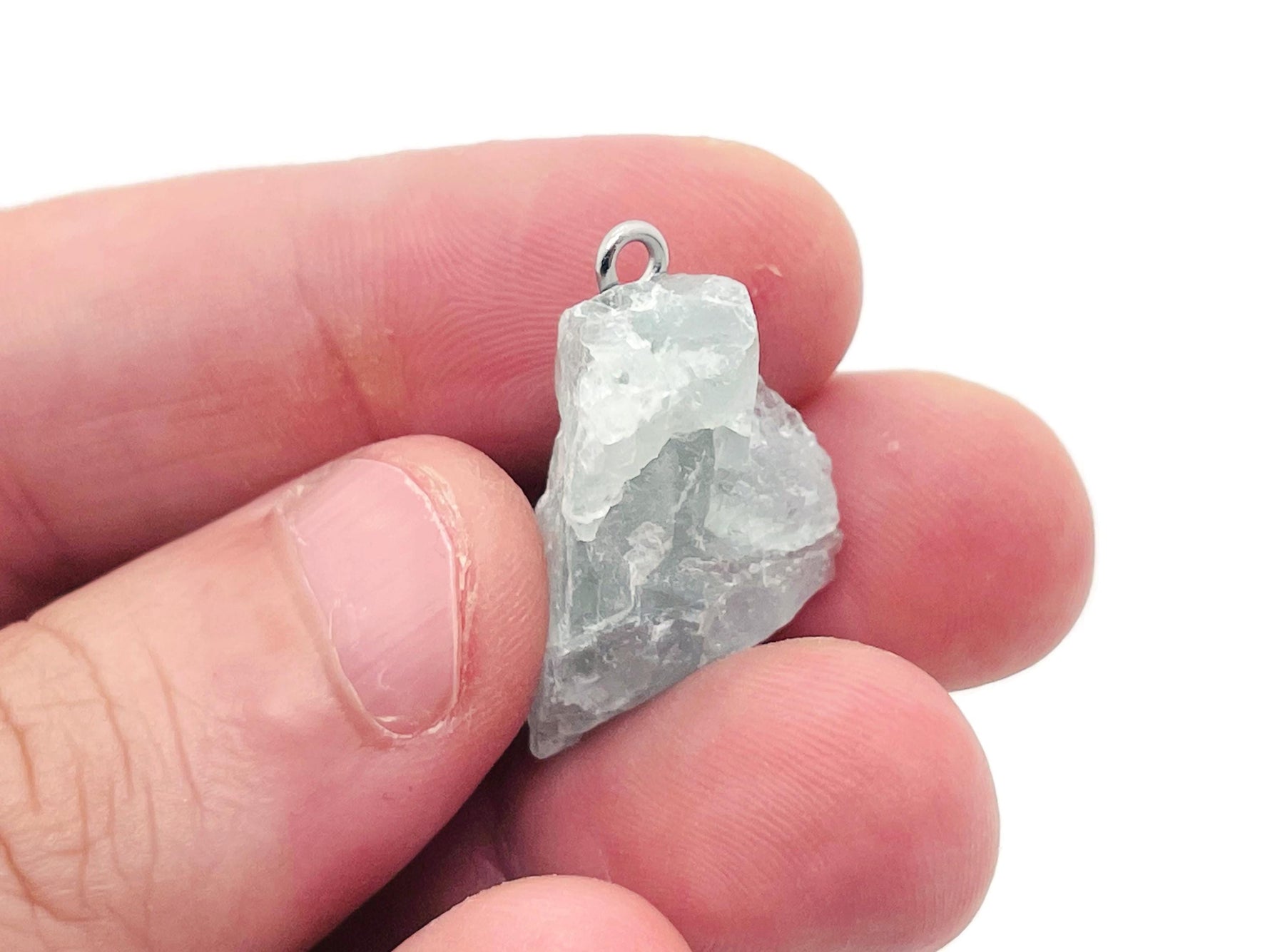 Purple fluorite crystal pendant from GemstoneGO featuring a polished, oval-shaped gemstone on a silver chain.
