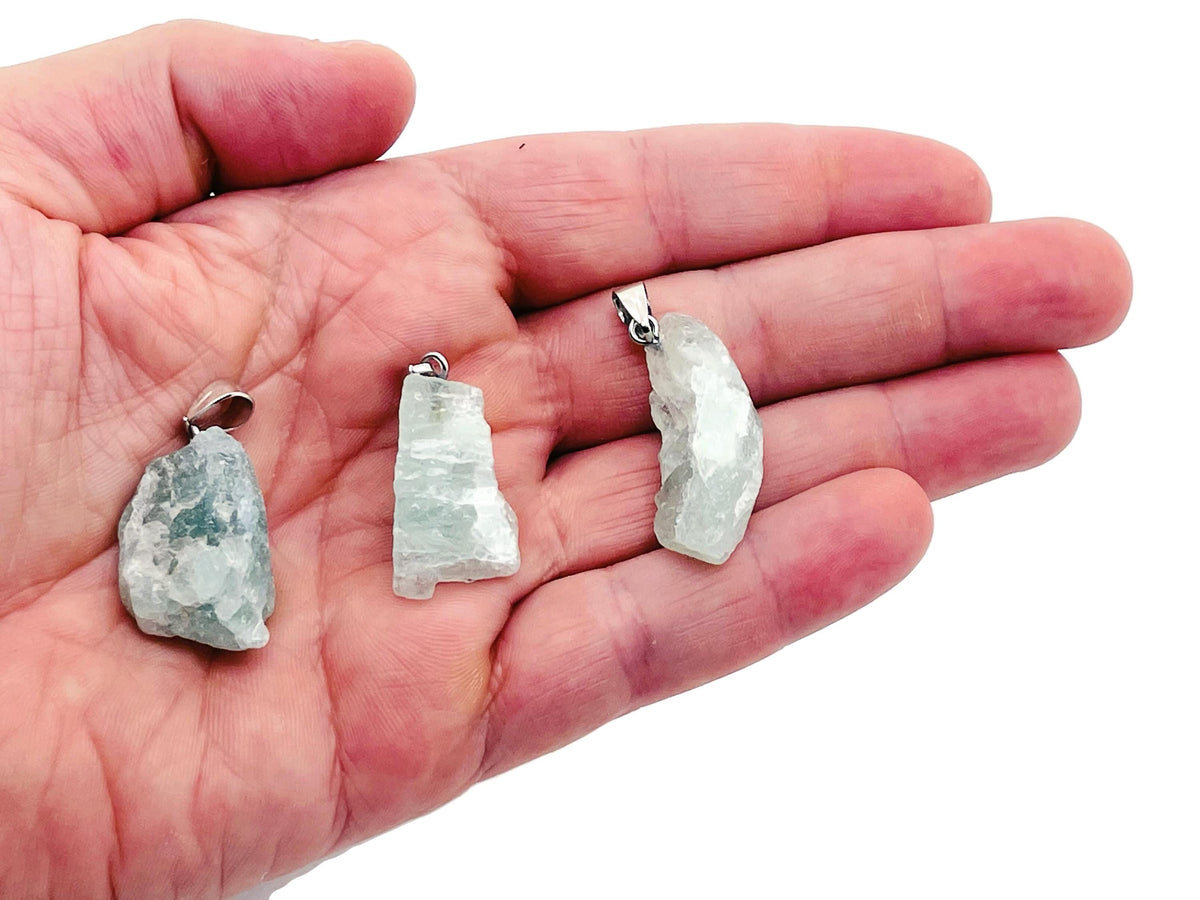 Fluorite crystal pendant from GemstoneGO featuring a polished green and purple fluorite gemstone on a silver chain.