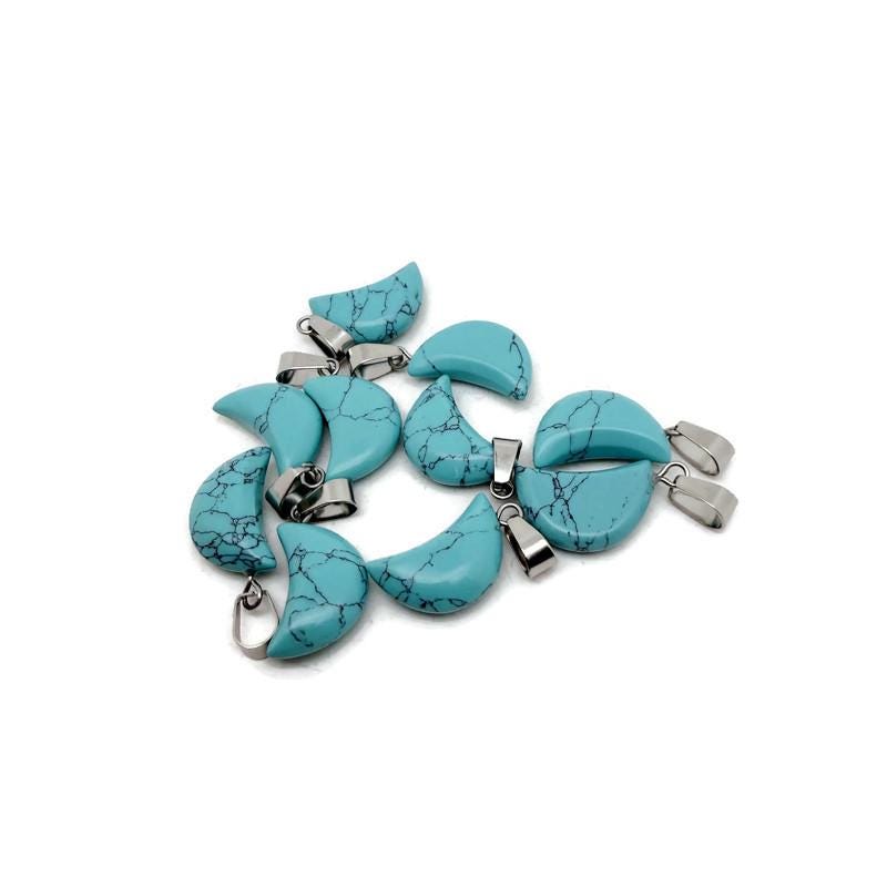 Turquoise Moon synthetic pendant from GemstoneGO, jewelry making supply, featuring a moon-shaped turquoise-colored stone.