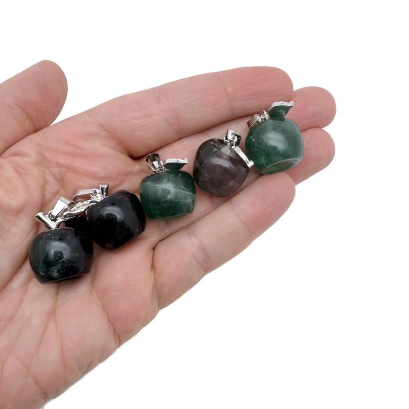 Mini fluorite apple crystal pendant from GemstoneGO, featuring vibrant green and purple hues with a polished gemstone finish.