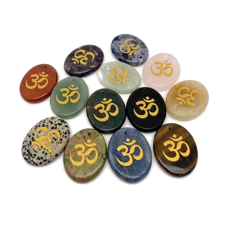 Crystal amulet engraved with Om symbol, drilled for easy wearing, representing spiritual insight and guidance from GemstoneGO.