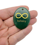 Infinity loop engraved crystal from GemstoneGO featuring a drilled symbol of endless love and protection.