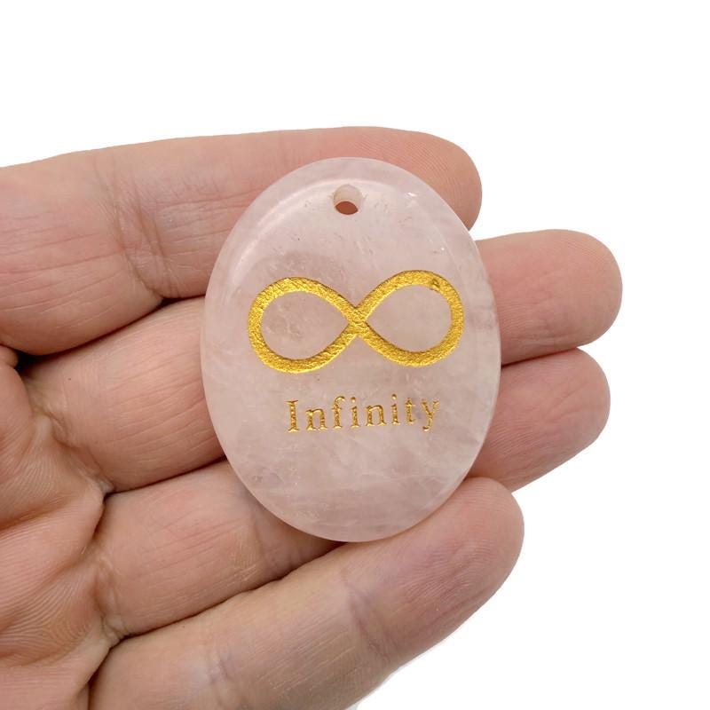 Crystal infinity loop pendant engraved with symbols of love and protection, drilled for jewelry, from GemstoneGO.