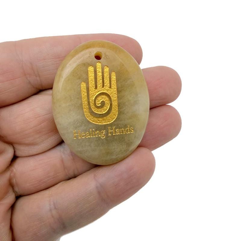 Healing Hands engraved crystal amulet by GemstoneGO, drilled energy healer gift pendant with intricate design visible.