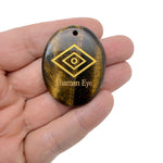 Drilled Shaman Eye engraved crystal pendant with intuitive energy protection by GemstoneGO, featuring intricate eye engraving.