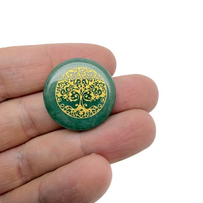 Engraved crystal Tree of Life pendant from GemstoneGO with drilled hole, spiritual connection stone amulet on a chain.