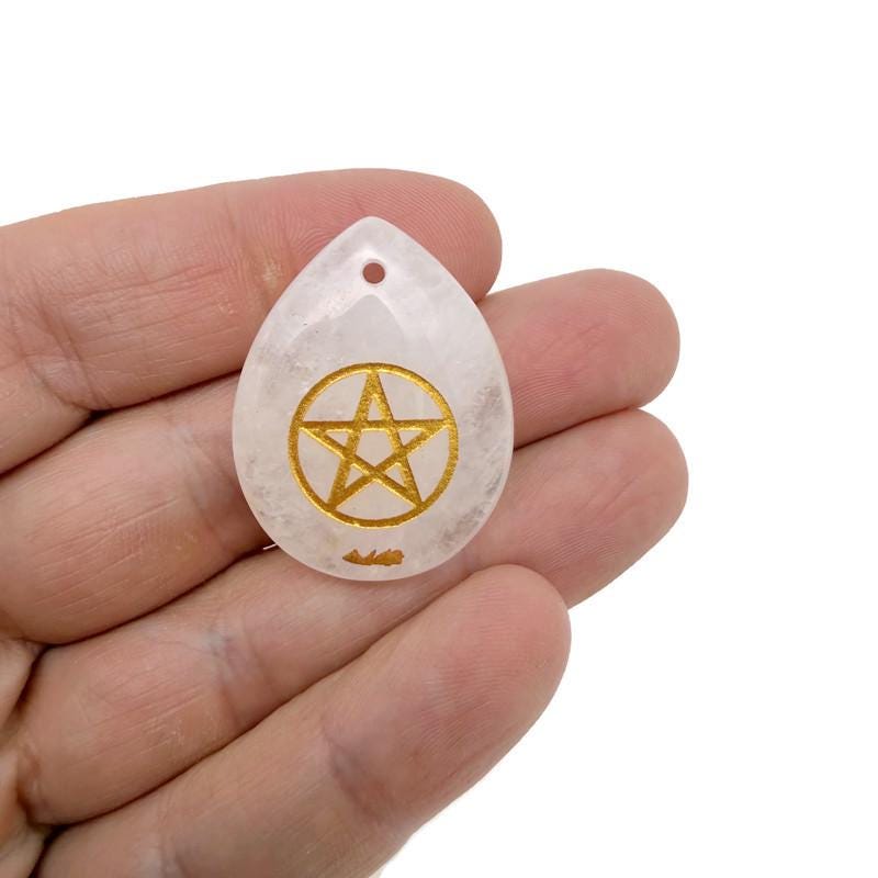 Crystalline pentagram pendant engraved with symbols, drilled for hanging, representing pagan protection and balance by GemstoneGO.