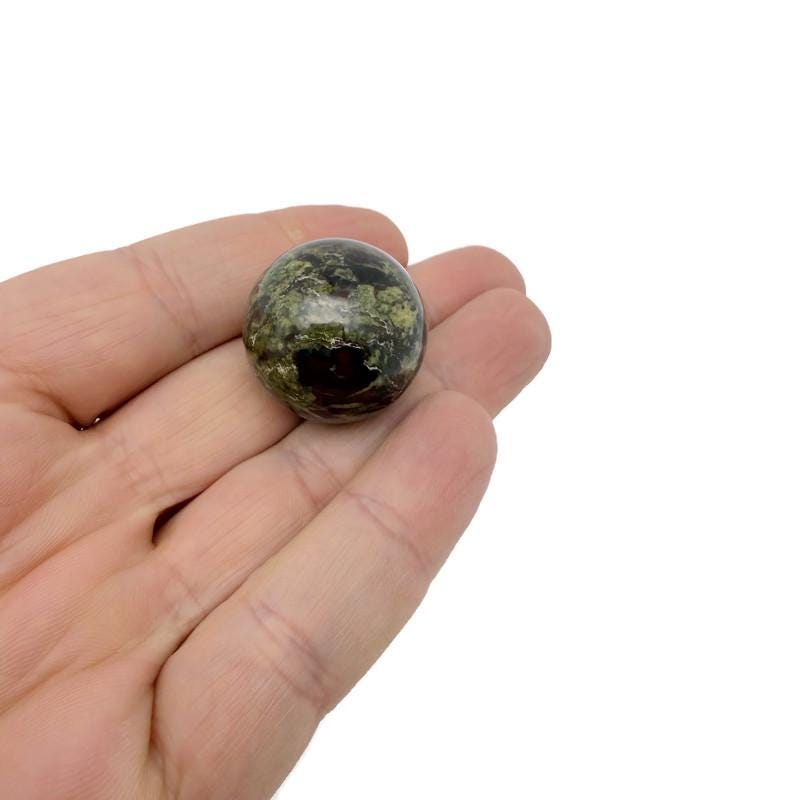 25mm natural gemstone crystal sphere from GemstoneGO, showcasing a clear, polished mineral ball with unique natural patterns.