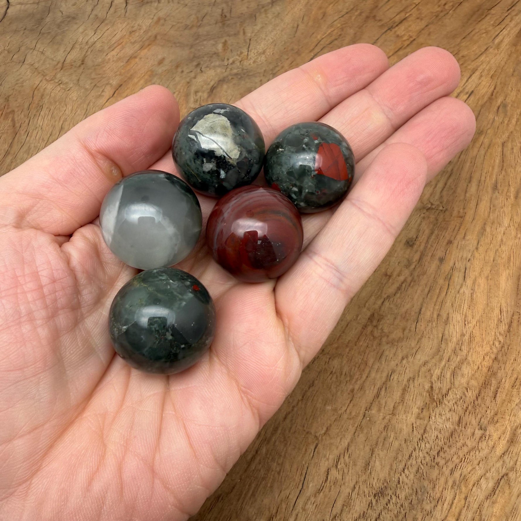 African Bloodstone sphere, 25mm crystal ball from GemstoneGO, showcasing deep green stone with red bloodstone inclusions.