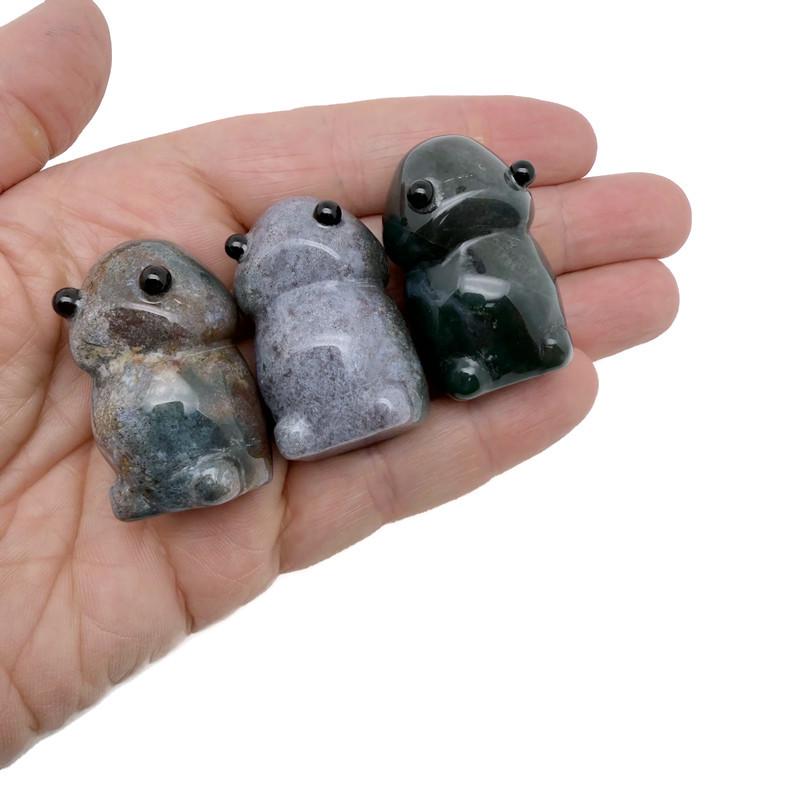 Handcrafted moss agate frog monster gemstone carving, detailed creature statue with natural green and earthy tones.