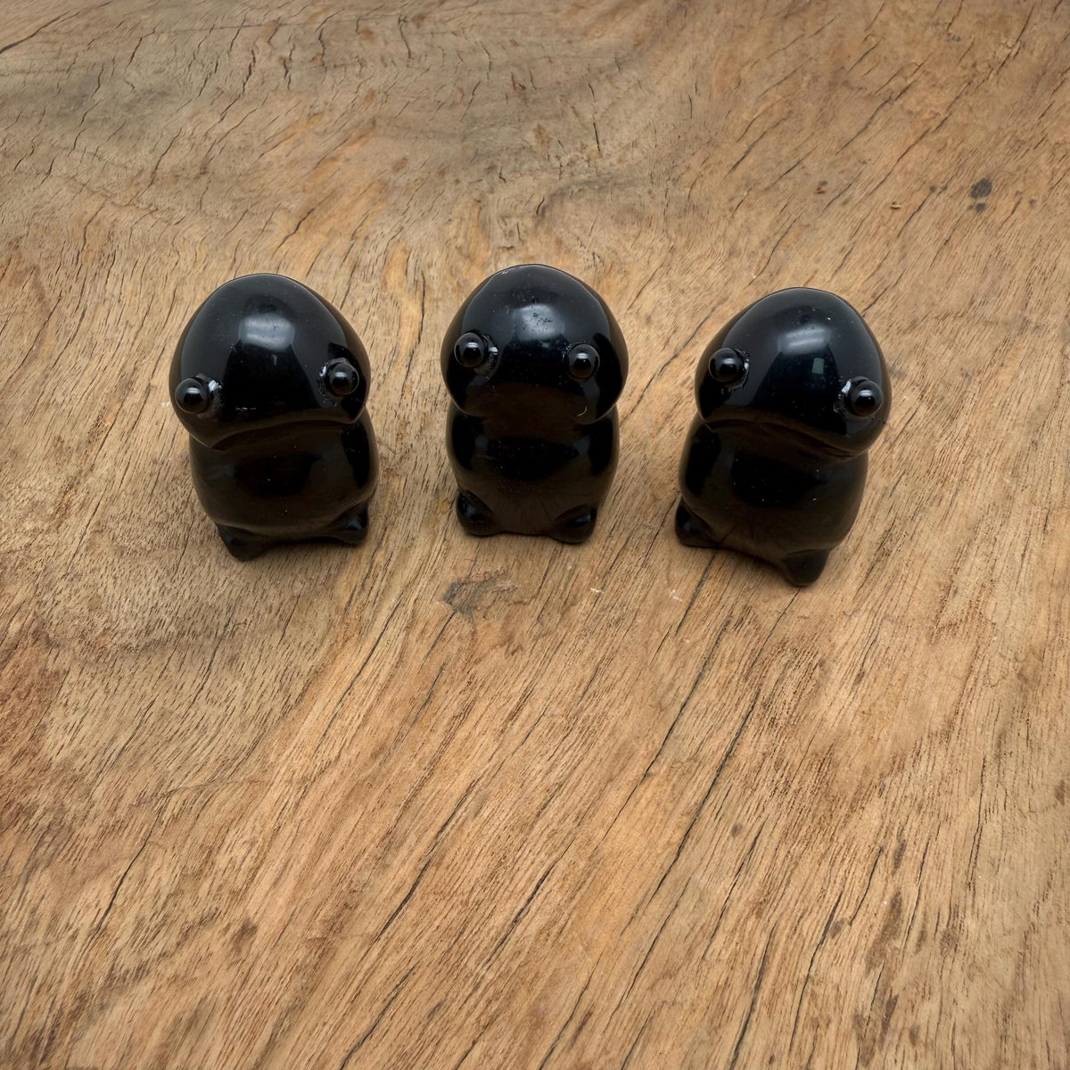 Handcrafted obsidian frog monster gemstone carving with detailed features, displayed as a creature statue.