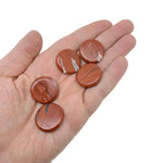 Round red jasper flat gemstone slab, 25mm, showing smooth polished surface and vibrant red color from GemstoneGO.
