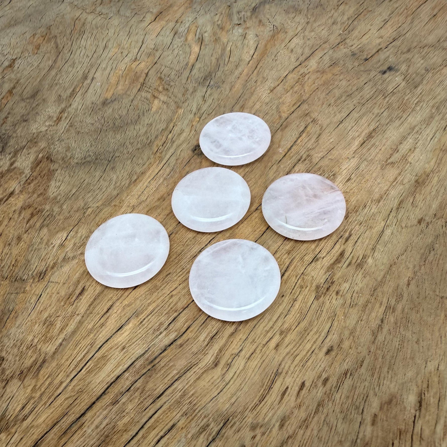 Round rose quartz flat gemstone slab, 25mm, from GemstoneGO, showcasing smooth polished pink crystal with natural stone details.