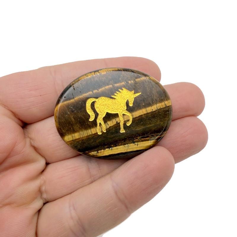 Animal engraved crystal gold totem stone by GemstoneGO featuring a detailed animal engraving on a clear and gold-toned crystal.