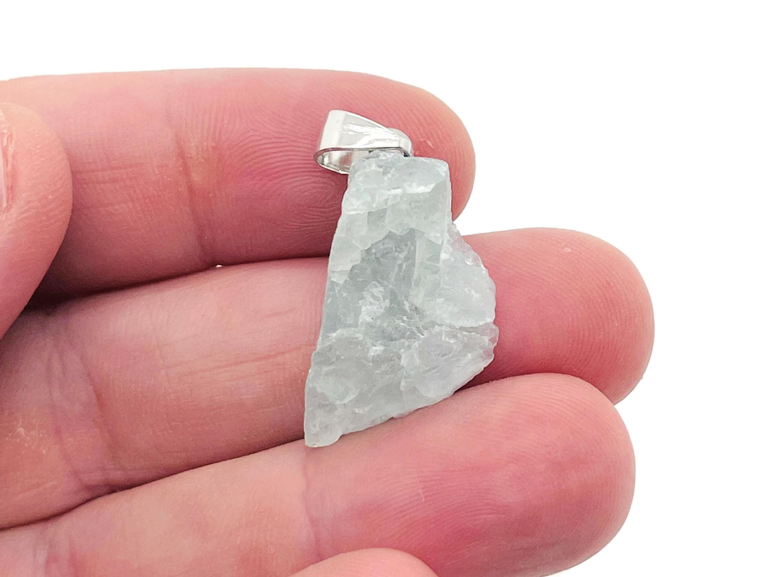 Fluorite crystal pendant from GemstoneGO showing a vibrant green and purple gemstone on a silver chain.