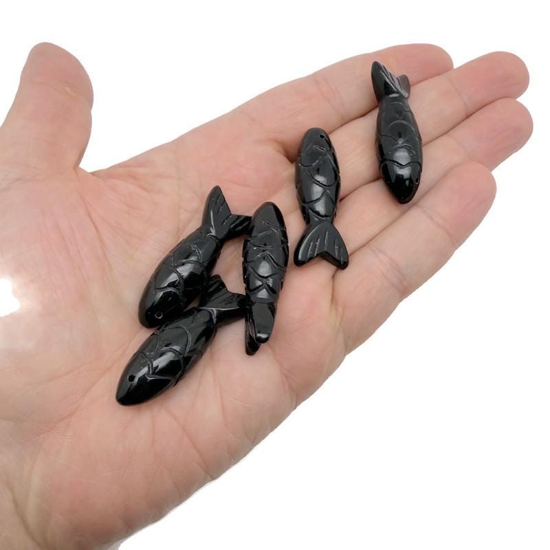 Obsidian fish gemstone pendant with intricate design, serving as a lucky fishing charm, from GemstoneGO.
