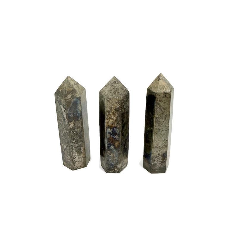 Pyrite obelisk tower crystal from GemstoneGO, showcasing a metallic gold finish and natural geometric shape on a white background.