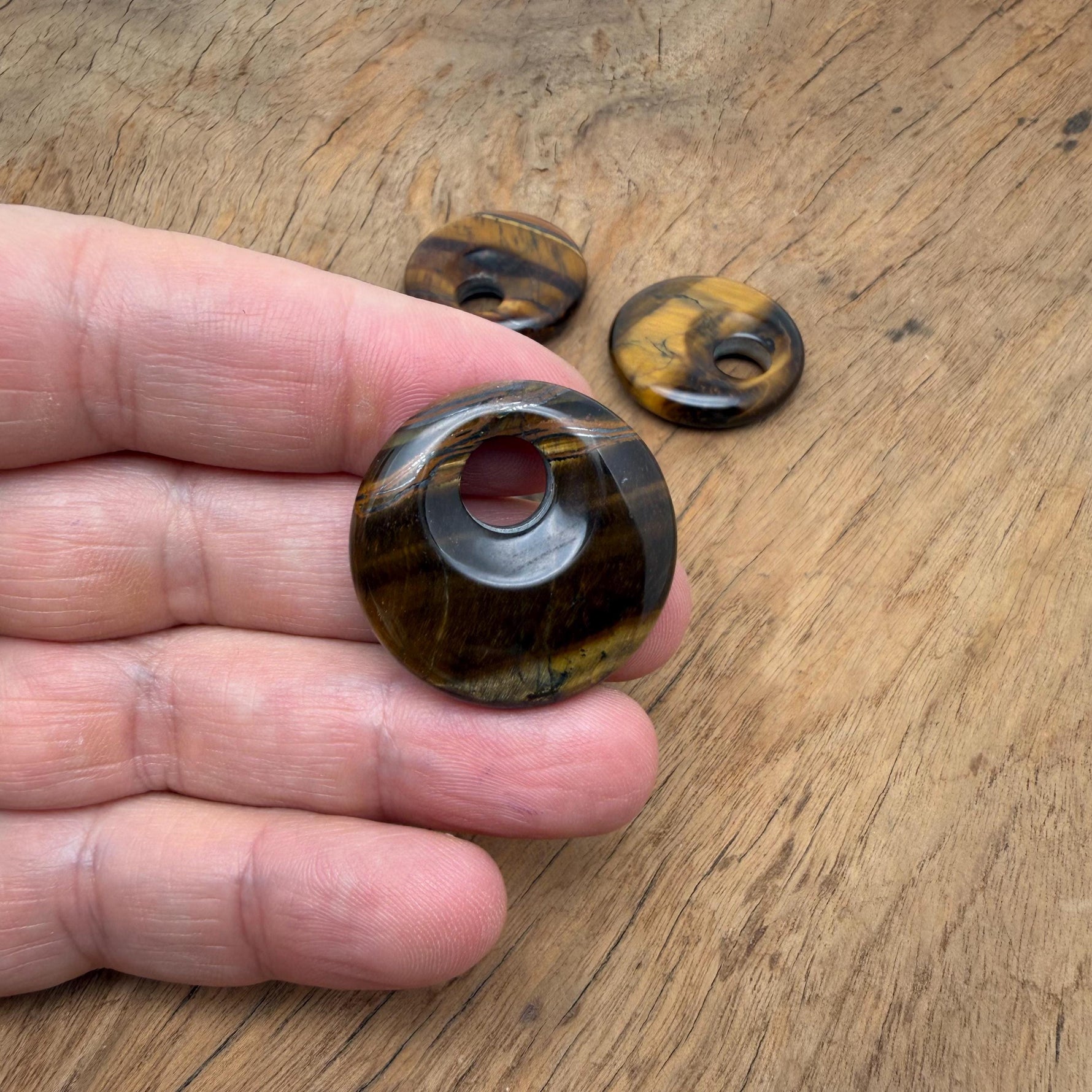 Tiger Eye crystal donut pendant, 30mm Pi stone from GemstoneGO featuring rich golden-brown hues and smooth polished surface.